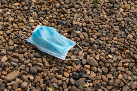 Used medical mask thrown out on the street.
  The mask that has been discarded after use.の写真素材