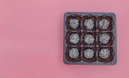 Coconut petit four is a juicy chocolate sponge cake with coconut filling and topping with coconut flakes.の写真素材
