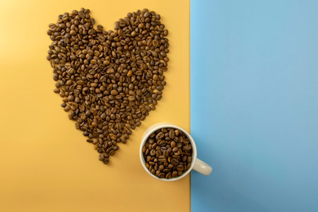 Coffee beans in a cup and creative pattern on a yellow background. View from above.の写真素材