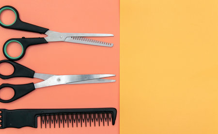 Comb and scissors on a colorful background. Barber tool. View from above