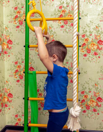 Child on the Swedish wall. A sporty and active child goes in for sports at home.の写真素材