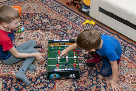 Children play at home sitting on the floor, kids soccer board game toys, children boardの写真素材