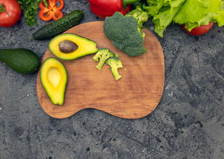 Fresh raw vegetables with pepper wedges. On a black concrete background. Healthy eatingの写真素材