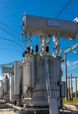 transformer substation with many connected high voltage wires and cables, transformers of different...