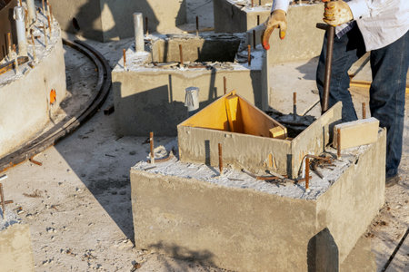 A worker removes wooden formwork after the concrete structure hardens at a construction site.の写真素材