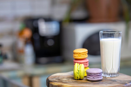 Close-up of a colorful macaroon or macaron with a glass of milk.の写真素材