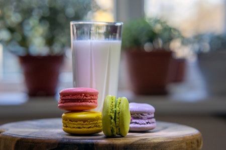 Assortment of delicate colorful macaroons and a glass of milkの写真素材