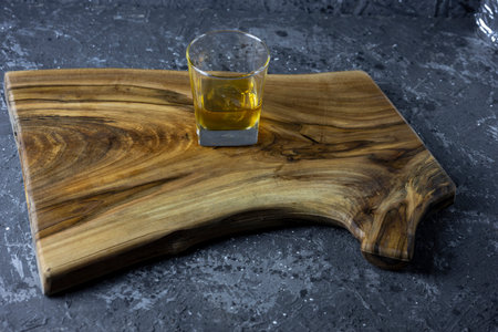 Glass of whiskey with natural ice. Rough dark background. copyspace.の写真素材