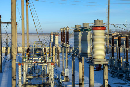 Top view of a high-voltage substation with circuit breakers and disconnectors. Early morning in winter.の写真素材