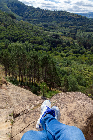 Feet in sneakers, hiker, selfie relaxing overlooking green landscape outdoors, travel lifestyle concept, active summer vacation, adventureの写真素材
