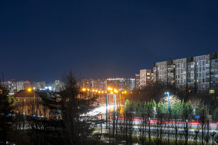 Night scenes in an urban environment with lights and light trails from passing cars.の写真素材