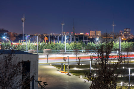 Light trails against the backdrop of a nightly luminous city.の写真素材