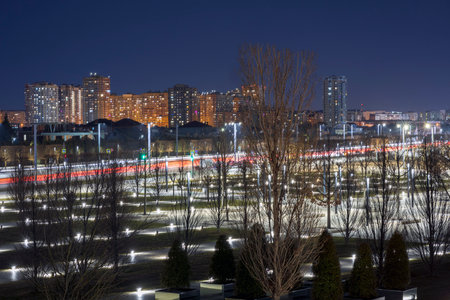 Light trails against the backdrop of a nightly luminous city.の写真素材