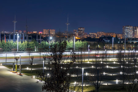 Night scenes in an urban environment with lights and light trails from passing cars.の写真素材