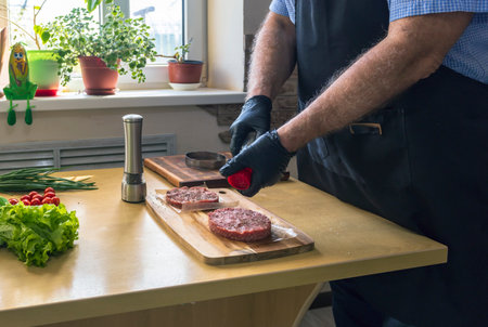 Man making hamburger patties at the table, close-upの写真素材