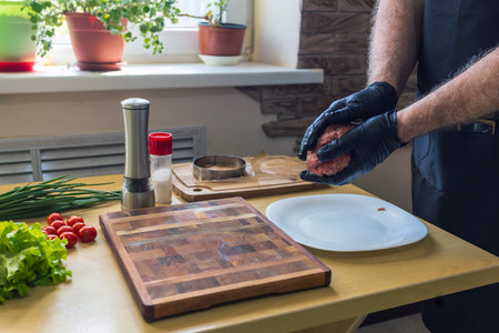 Cooking blanks for burgers from fresh ground beef in the home kitchenの写真素材