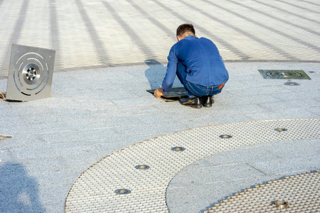 Pipes, nozzles and lighting of the dry fountain are being serviced. Preparing to start the fountain...