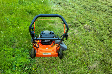 lawncare. Lawn moving with a lawn mower. Man moving grass with a lawn mower