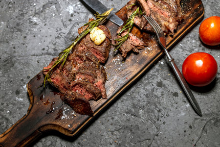 Medium steak on a wooden board, selected focusの写真素材