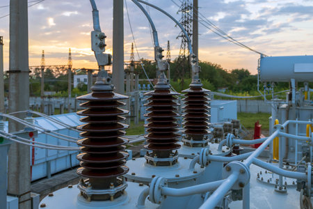 High and low voltage transformer bushings with electrical insulation and electrical equipment at a power substation.の写真素材