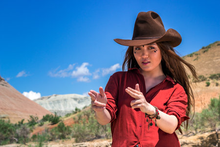 girl cowboy holds his fingers like a gunのeditorial素材