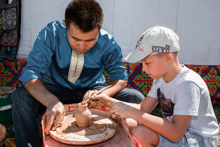 Almaty region, Kazakhstan - August 27, 2016. Master class on pottery at the festival of Kazakh national culture and crafts "The Legend of the Great Steppe". The festival is held annually in late summer. At the festival his works are artisans, serves natioのeditorial素材