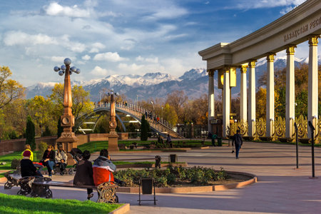 Almaty, Kazakhstan - October 27, 2014 People relaxing in the park with views of the mountains. Park of the first president in Almaty - a favorite place of citizens at any time of the year. In summer it is hold festivals and holidaysのeditorial素材