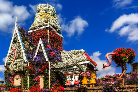 Dubai, UAE - January 5, 2017. Dubai Miracle Garden - Floral house, dolls and ostrich on the background of clouds. Dubai Miracle Garden is the largest natural flower garden in the worldのeditorial素材