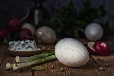 Chicken egg, onion and radish. Still life. Rustic, moonlight, magical light, low keyの写真素材