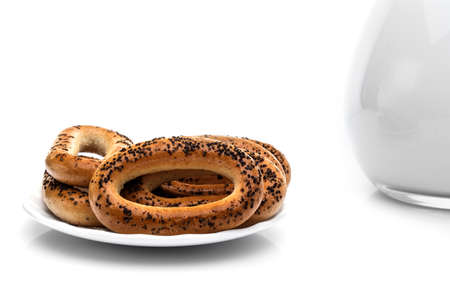 Whole bagels with poppy seeds on a plate. Sweet bread. isolatedの写真素材