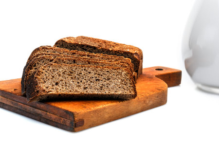 Black dietary bread on a chopping board. isolated