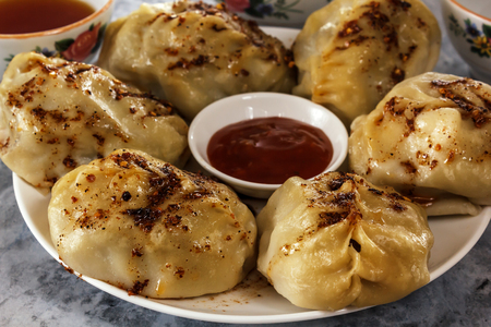 Manti on a plate with sauce. Traditional food of the inhabitants of Central Asiaの写真素材