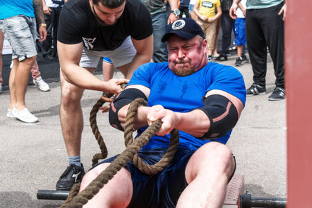 Almaty, Kazakhstan - May 28, 2017. Strong man pulls the rope. City fesitwal sport on the street for...