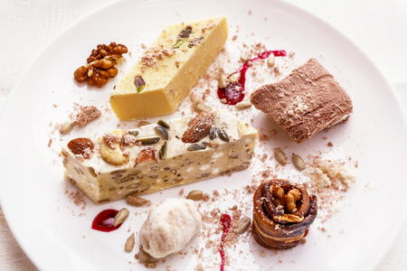 Halva, marmalade, raisins, walnuts, dried melon and sunflower seeds. Oriental sweets on a plateの写真素材