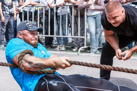 Almaty, Kazakhstan - May 28, 2017. Strong man pulls the rope. City fesitwal sport on the street for...