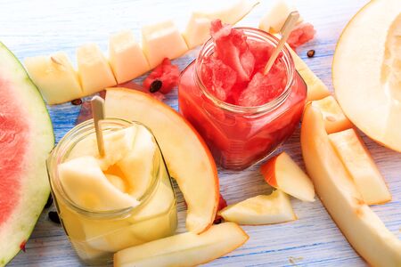 cocktail of watermelon and melon. Fresh watermelons and melons cut into pieces on a wooden backgroundの写真素材