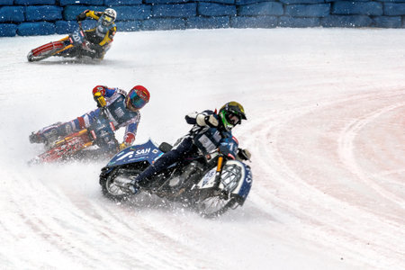 Almaty, Kazakhstan - February 15, 2015. Three motorcyclists in a steep ice bend. International competitions in motorcycle racing on ice. Winter Speedway.のeditorial素材
