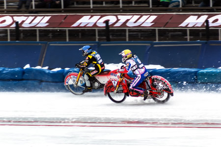 Almaty, Kazakhstan - February 15, 2015. Race of two motorcyclists on ice. International competitions in motorcycle racing on ice. Winter Speedway.のeditorial素材