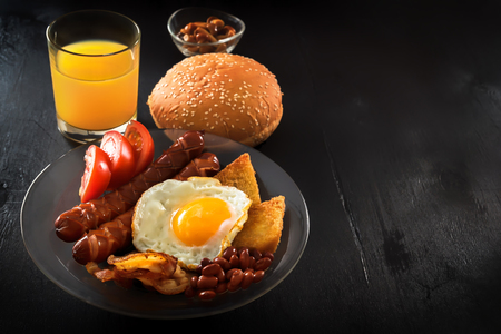 Classic English breakfast on a black table. Plenty of space for textの写真素材