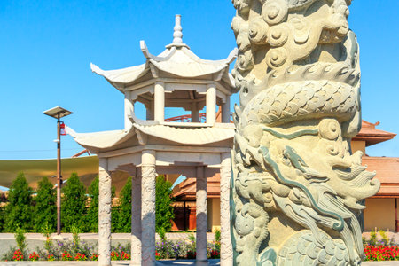 Pagoda, Chinese pillar with dragons, flower beds - the Asian sector in Dubai Safari Park - a zoo where tourists not only watch the animals, but also relax on the territory of beautiful modern oasesのeditorial素材