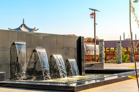 Decorative fountain on the background of the pagoda in Dubai Safari park. One of the places where tourists can relax on a hot day after sightseeingのeditorial素材