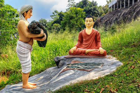 Kandy, Sri Lanka - January 9, 2018. Sculptural composition man brought an offering to Buddhaのeditorial素材