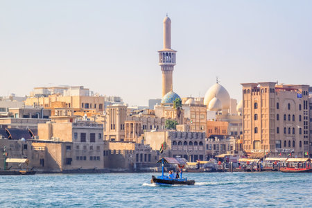 Dubai, UAE - January 16, 2018. Small wooden boat tourists over the bay Creek in the old part of town on a sunny dayのeditorial素材