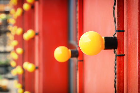 Abstract background of yellow lamps on a red wall background. Copy spaceの写真素材