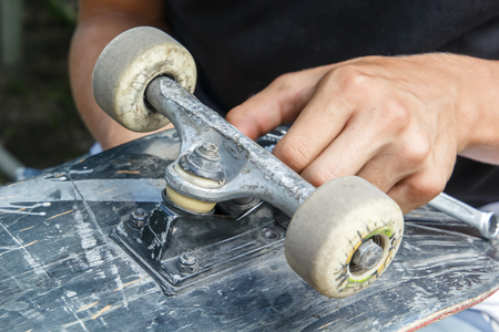 Repair of the wheel pair of skateboarding in the home workshopの写真素材