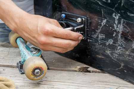 Mounting the wheel pair of skateboarding in the home workshopの写真素材