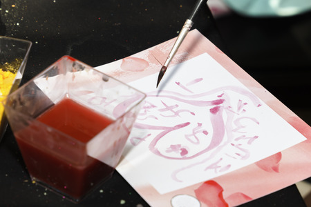 brush paints on paper in a creative workshop in the street on a sunny day. Copy spaceの写真素材