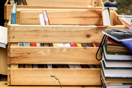 Books in a wooden box are prepared for sale at a street fair. Close-upのeditorial素材