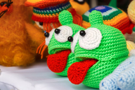 Colorful knitted handmade toys are on display for sale at a souvenir shop on the market. Close-upの写真素材
