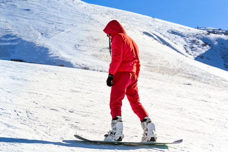 snowboarder quickly rolls down on a sunny day. Copy spaceの写真素材